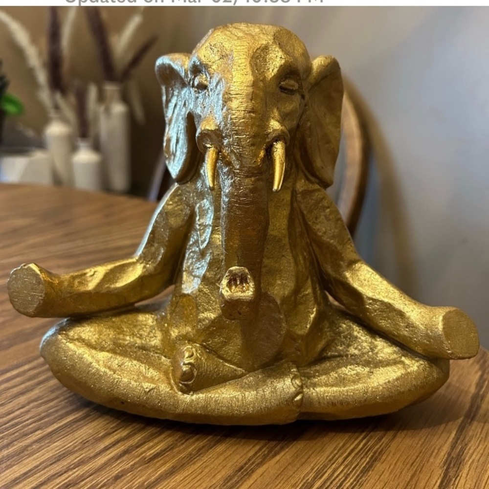Gold tone elephant in yoga pose